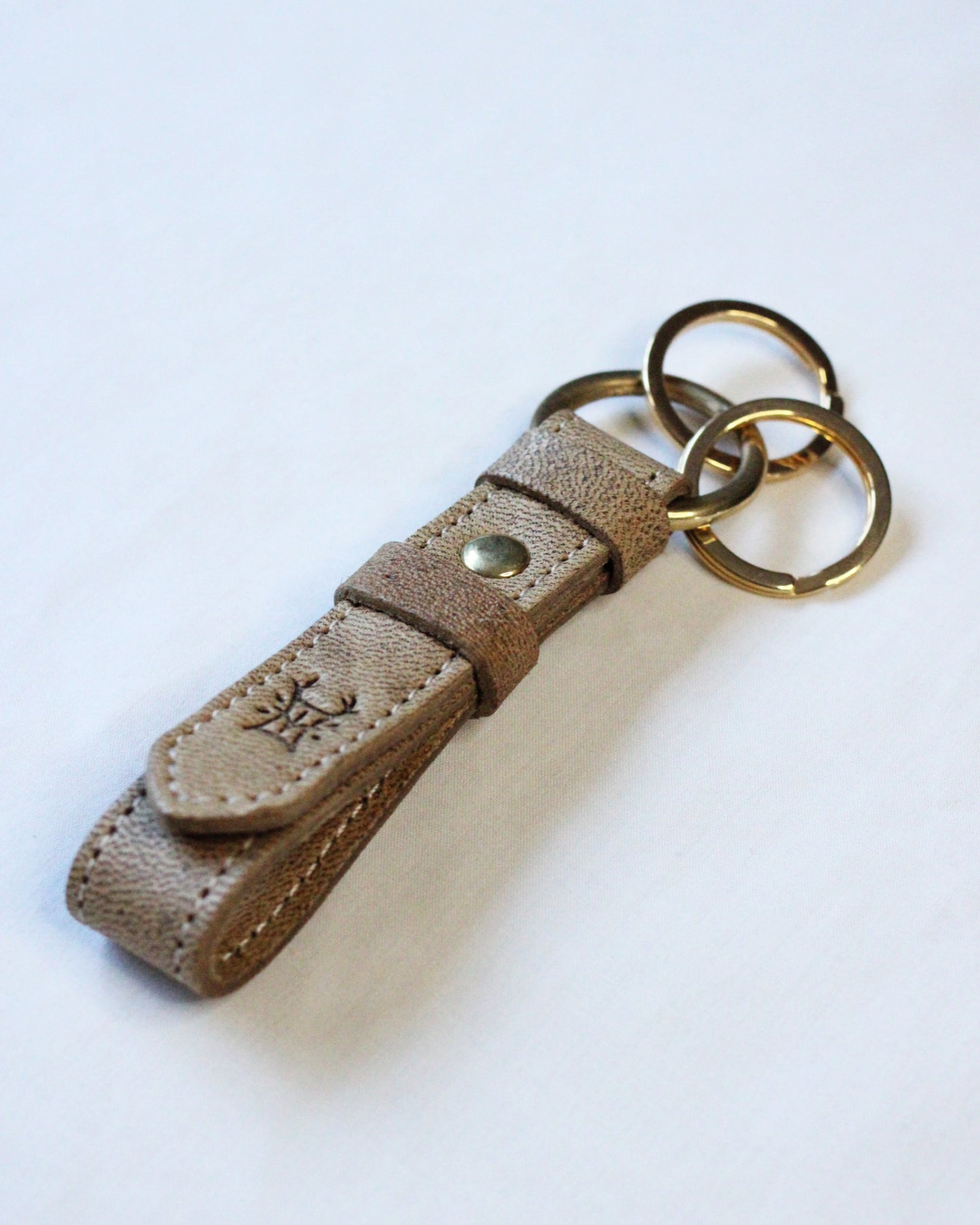Bay Tine Tannery Acorn key fob showing a detailed leather keychain with a metal ring and branding detail.