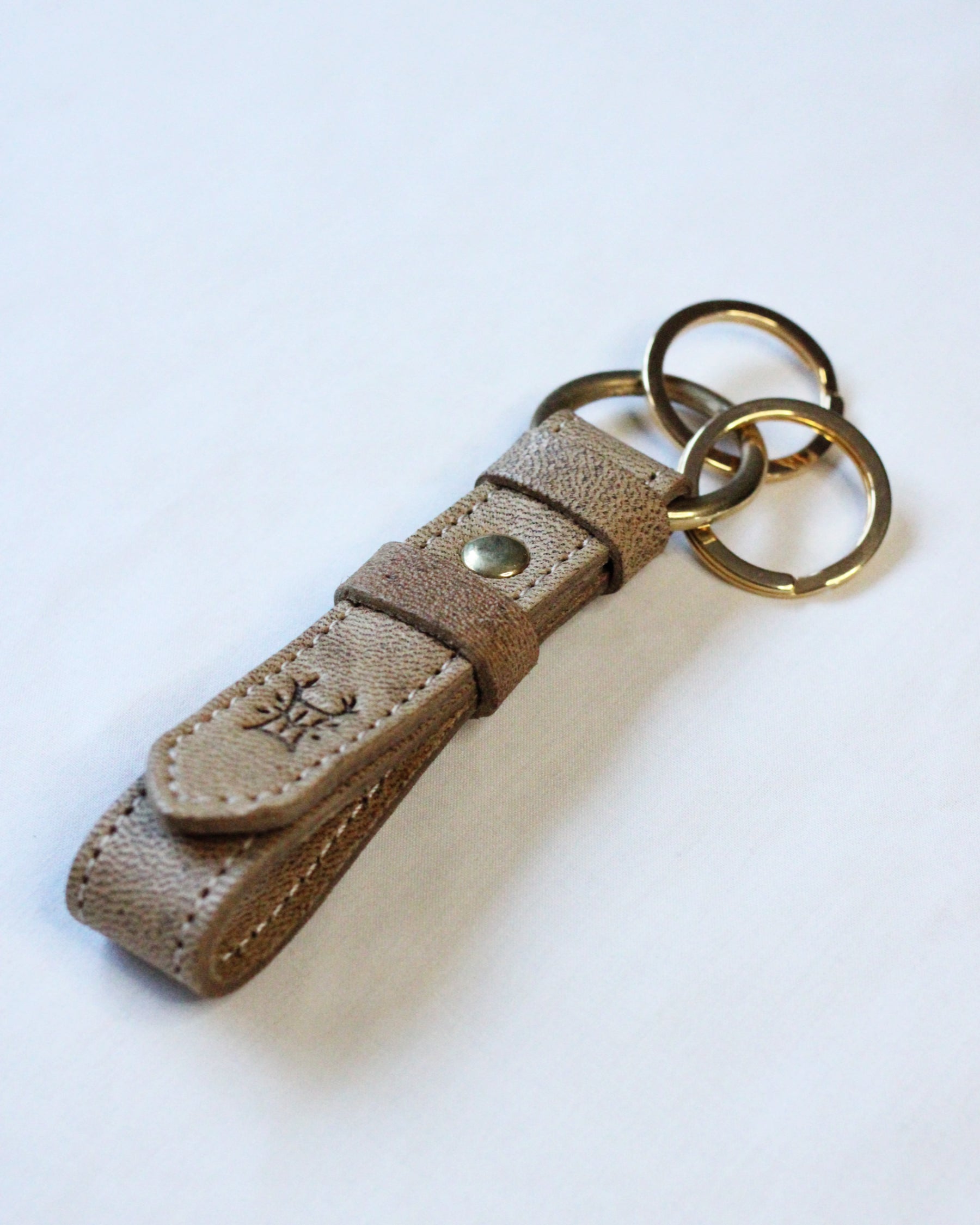 Bay Tine Tannery Acorn key fob showing a detailed leather keychain with a metal ring and branding detail.
