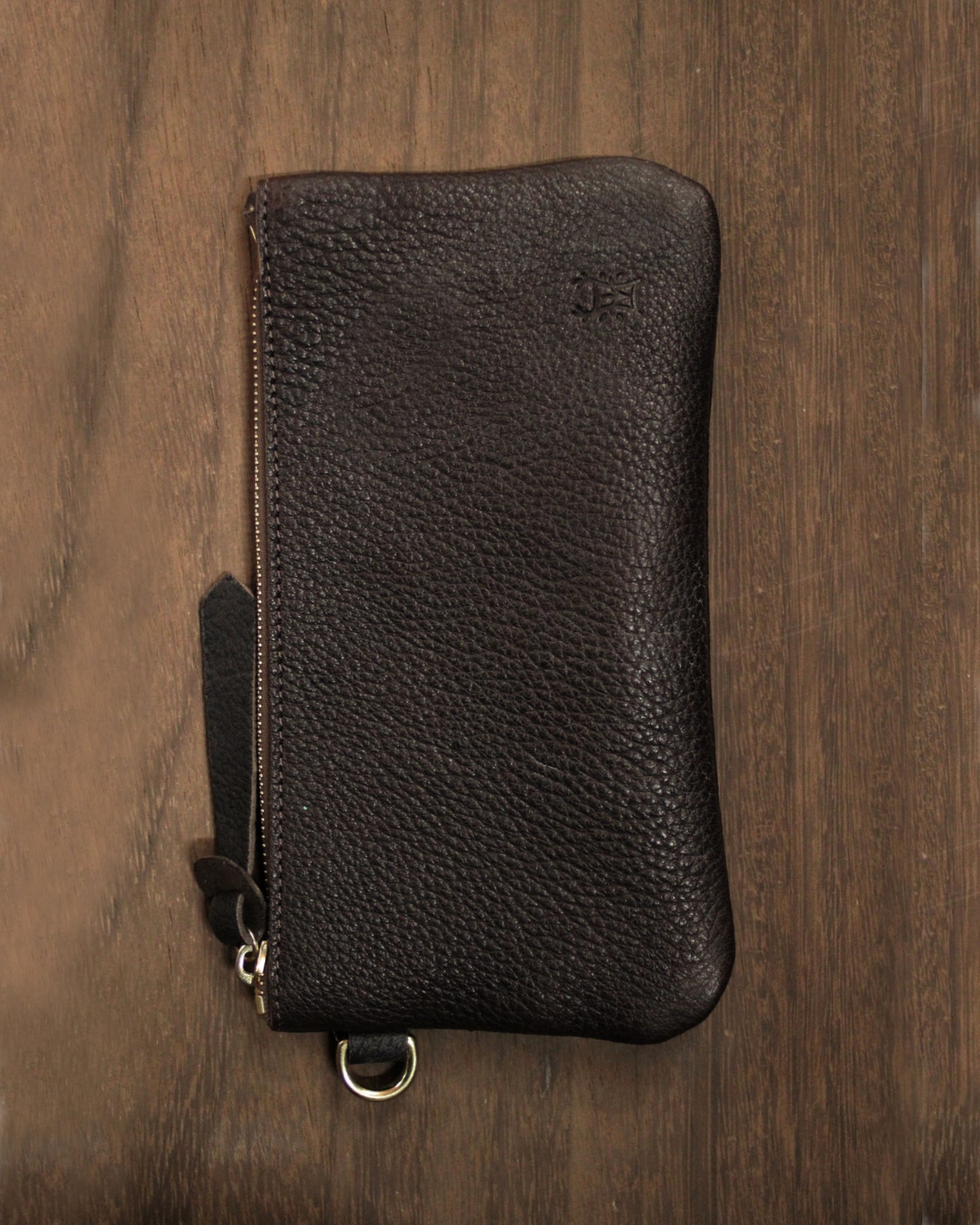 Brown leather zip pouch with "Dartmoor" embossed, compact Bay Tine Tannery accessory for travel or organization.