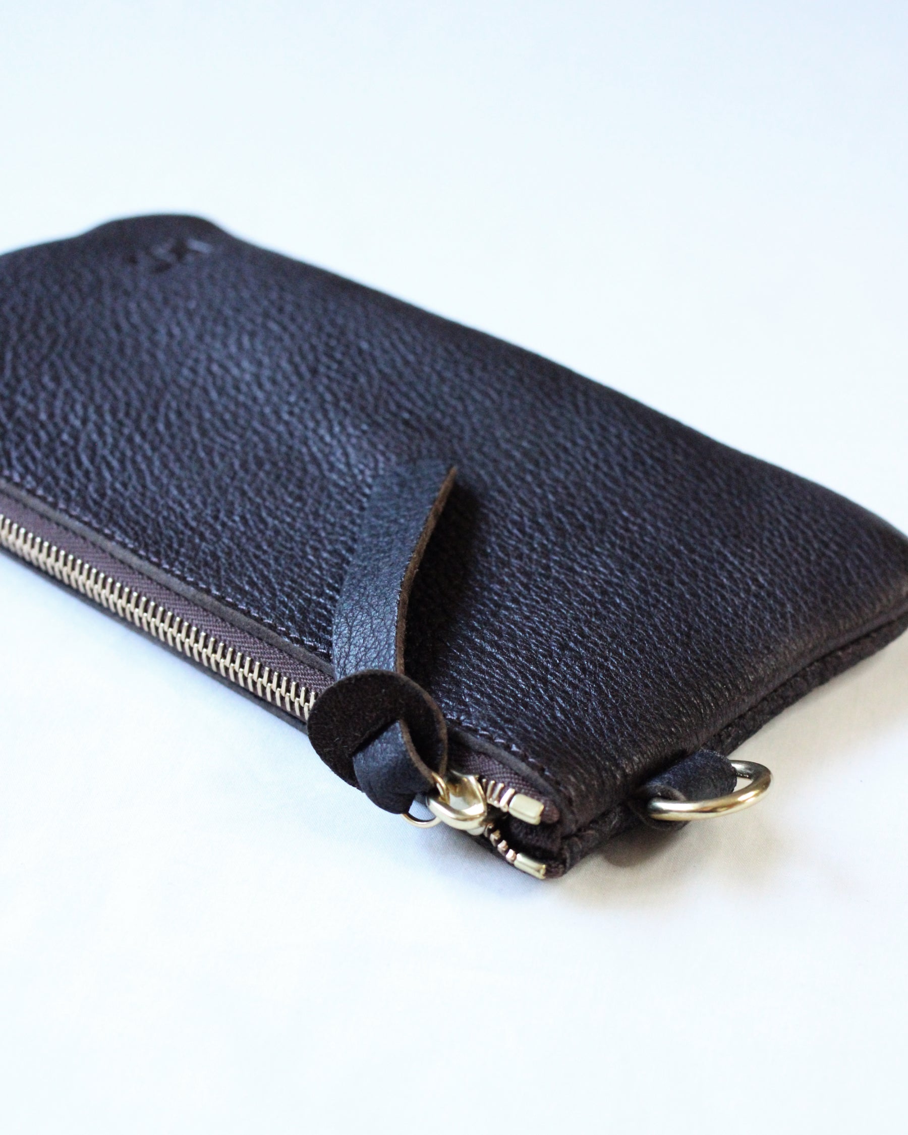 Brown leather zip pouch from Bay Tine Tannery's Dartmoor collection, featuring a compact design with a zipper closure.